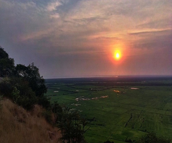 Sunset view on top of Wat Knang Phnom Krom overlooking rice fields