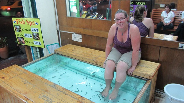 A tourist is being treated by doctor fish