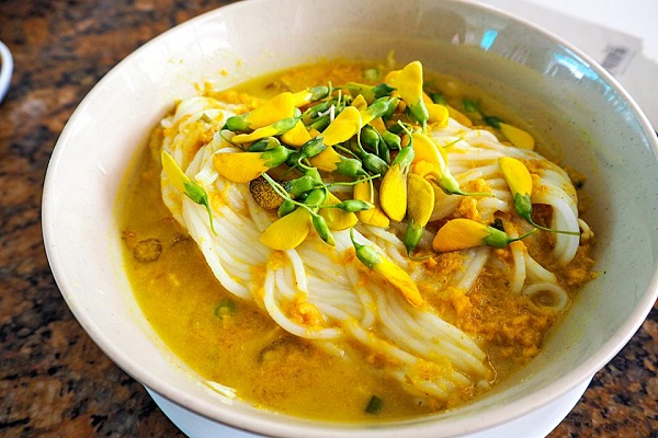 Nom Banh Chok with rich, buttery broth and tasty toppings