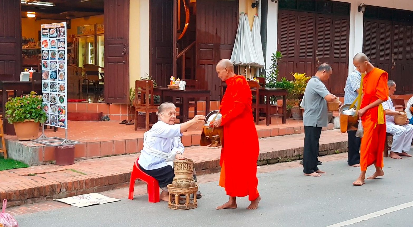 alms giving ceremony in Laos