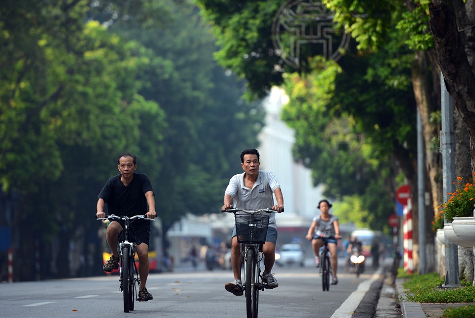 Riding around Hoan Kiem Lake in the early morning