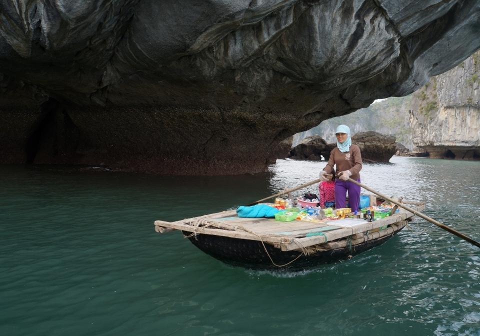 Sitting on the bamboo boat for Cua Van Floating Village Tour