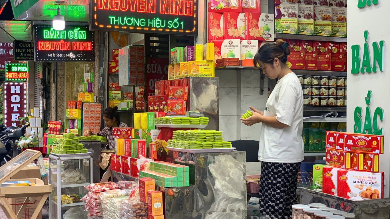 Local people organizing green sticky rice cake 