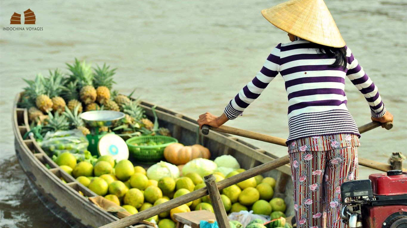 Boat of floating market carries pineapples and pomelos