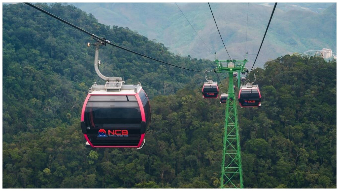 Modern cable car cabins transporting visitors over lush green forests to reach the Golden Bridge Vietnam at Ba Na Hills, Da Nang
