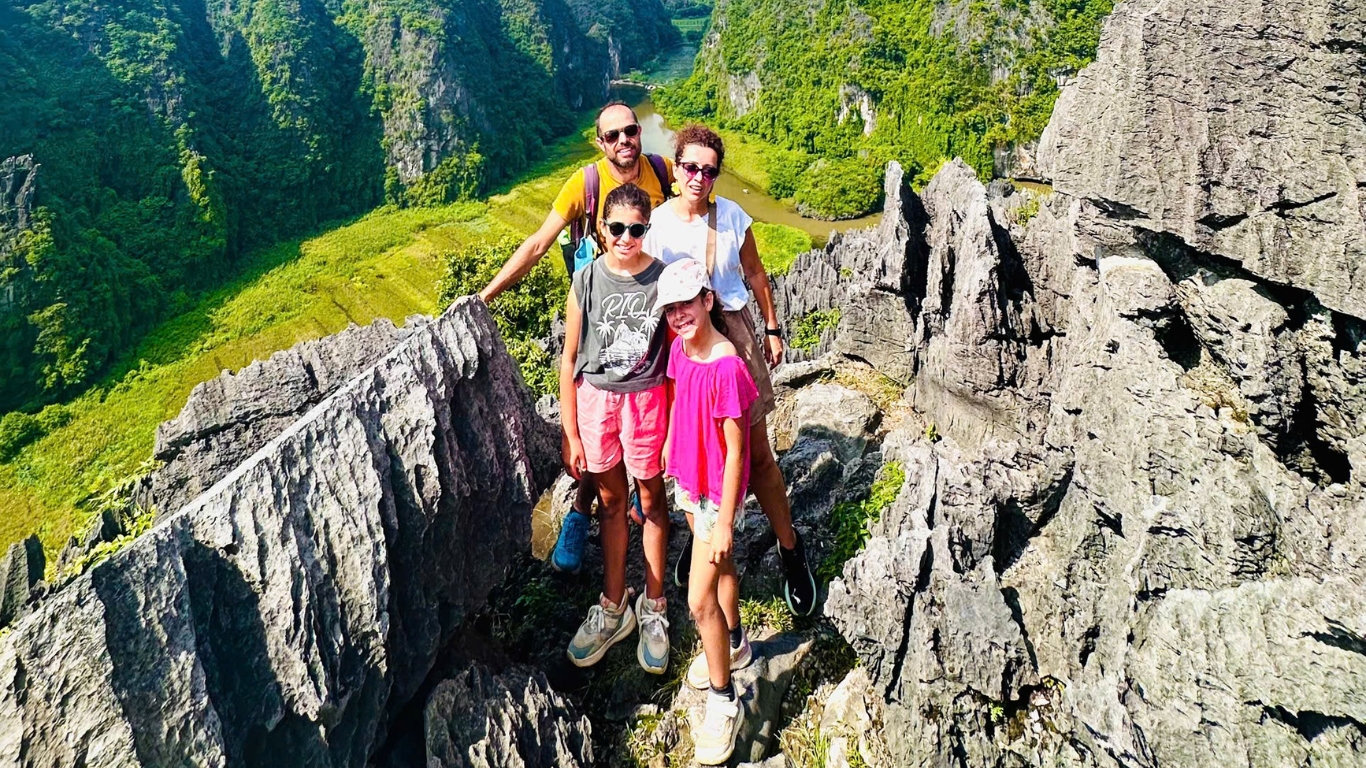 Family at Hang Mua viewpoint overlooking Tam Coc river bend