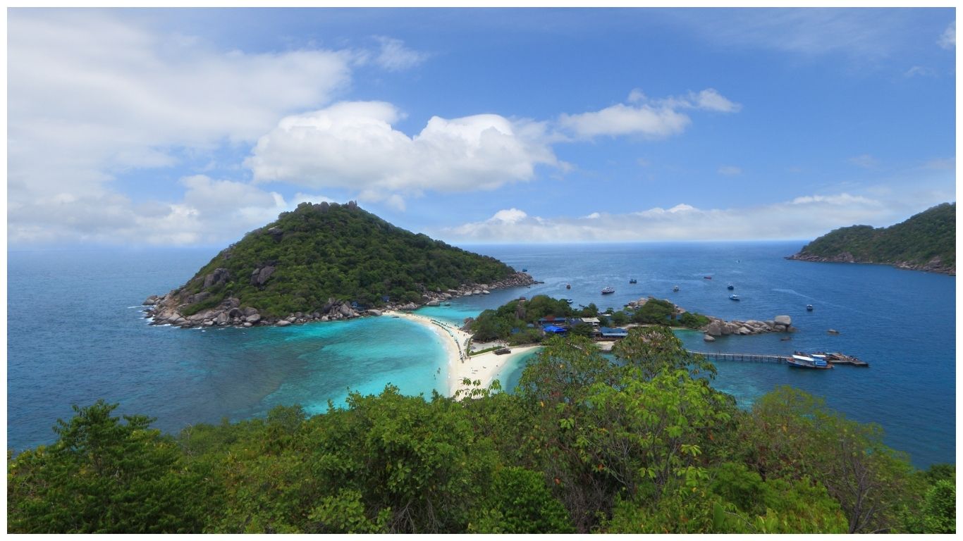 Aerial view of Koh Nang Yuan's white sand bridge and turquoise water in the Gulf of Thailand, showing clear sunny weather for Thailand in June