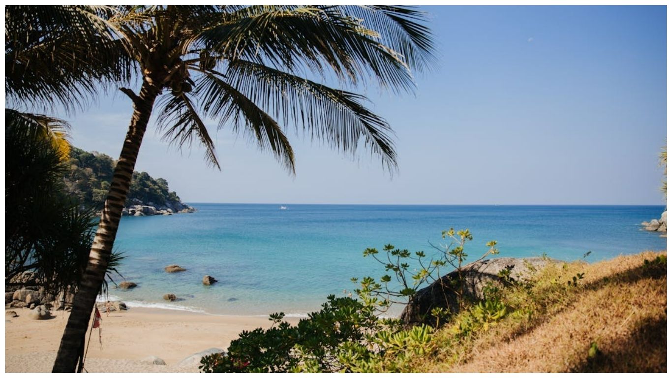 A beach in Phuket on the Andaman Coast under a mix of sun and clouds, representing typical weather conditions for Thailand in June