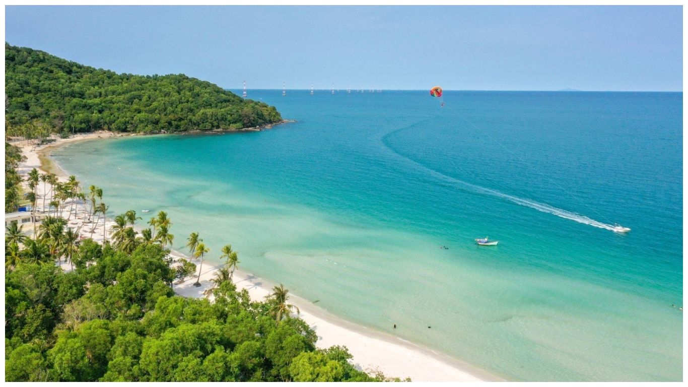 A split-screen image featuring the Bitexco Financial Tower in Ho Chi Minh City on the left and a tropical beach with turquoise water and palm trees in Phu Quoc on the right