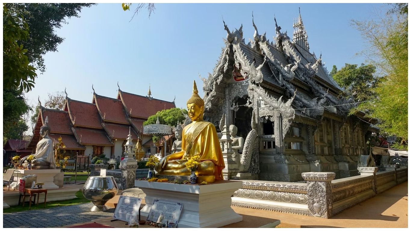The stunning Wat Sri Suphan (Silver Temple) in Chiang Mai, one of the best places to visit in Thailand, featuring a golden Buddha statue and intricate silver-colored carvings
