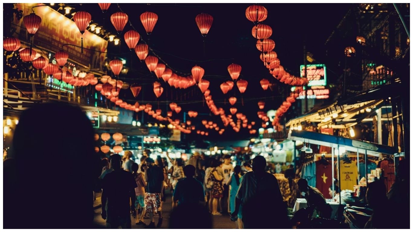 Tourists exploring the bustling Phu Quoc Night Market under red lanterns, a top activity during the best time to visit Phu Quoc