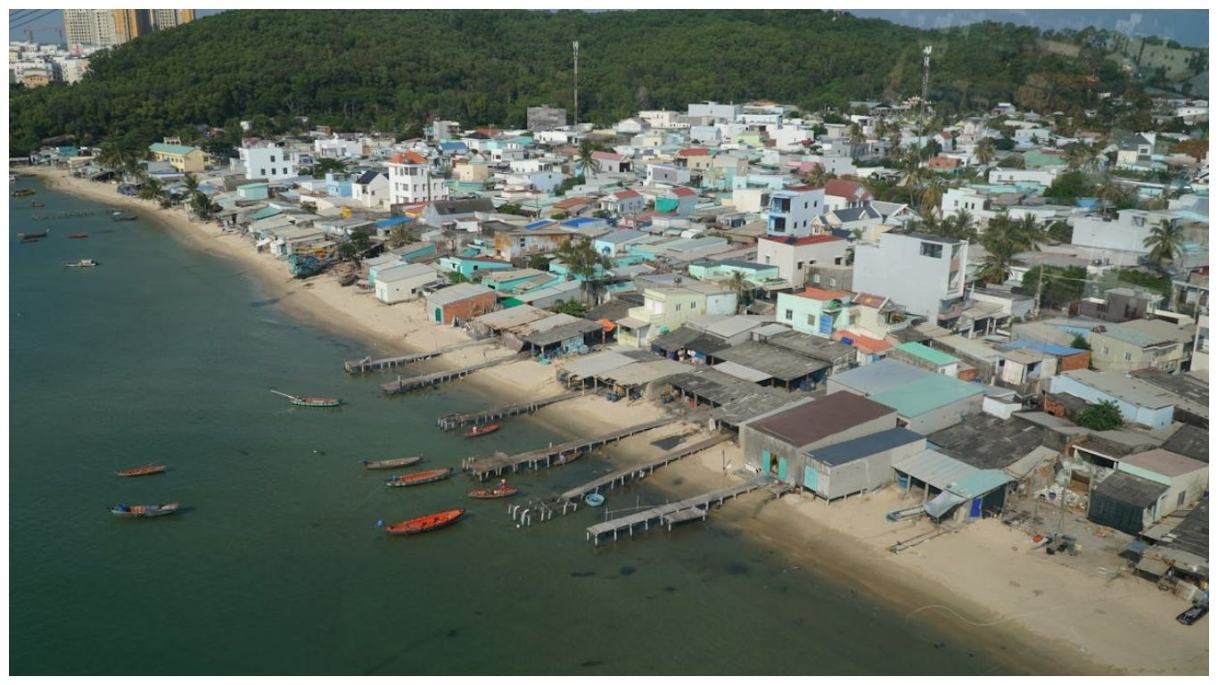 A panoramic view of a traditional fishing village and coastline, summarizing the diverse experiences available during the best time to visit Phu Quoc