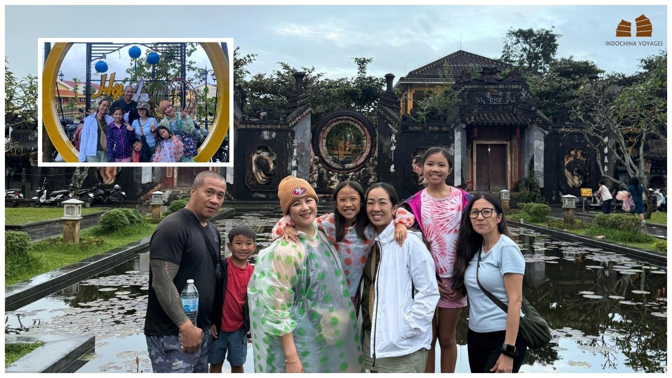 A happy family group exploring the historic temples and lantern-lit streets of Hoi An Ancient Town during their Central Vietnam itinerary