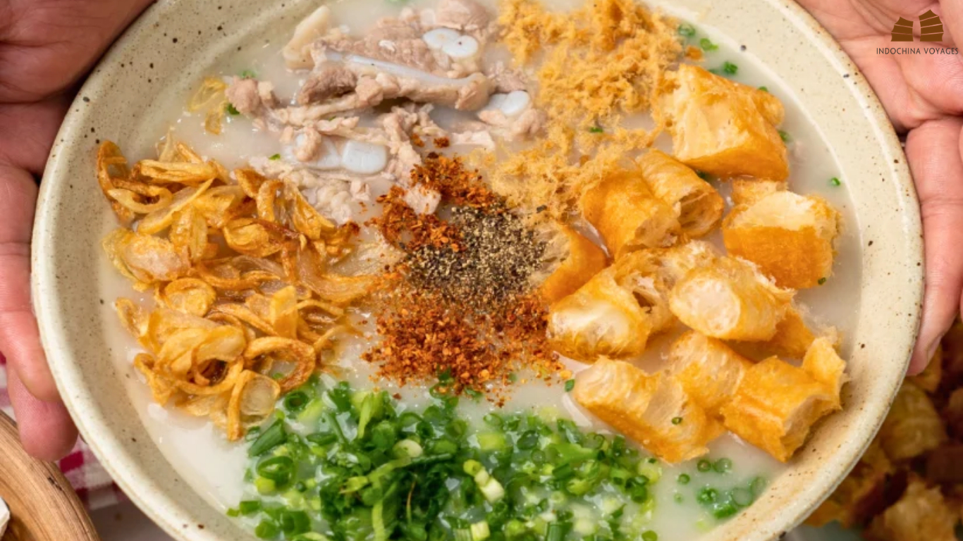 Bowl of chao suon rice porridge with pork ribs, fried shallots, scallions and fried dough sticks in Hanoi